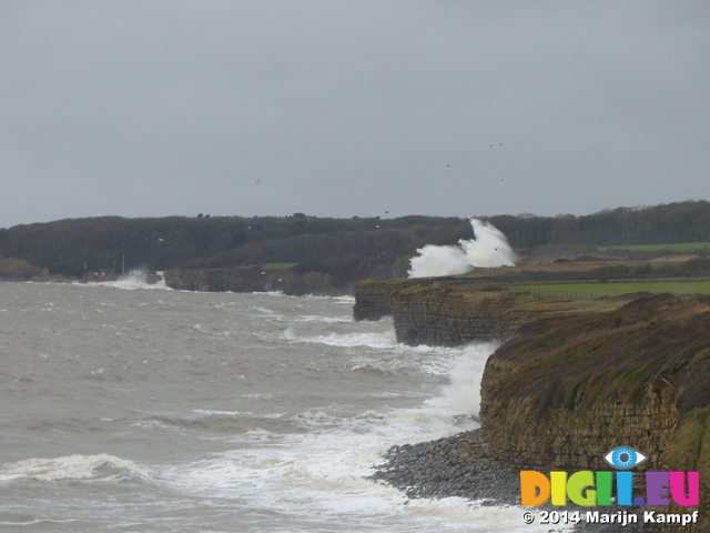 LZ00715 Waves crashing against cliffs at Llantwit Major beach